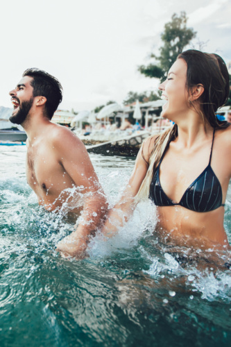 Sexy,Young,Couple,On,The,Beach,Having,Fun