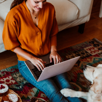 Young,Freelance,Woman,Working,From,Home,With,Her,Laptop,Accompanied